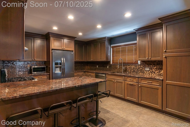 1432 N Custer Ave, Clawson, MI 48017 - kitchen with appliances with stainless steel finishes, tasteful backsplash, recessed lighting, dark stone countertops, and a breakfast bar