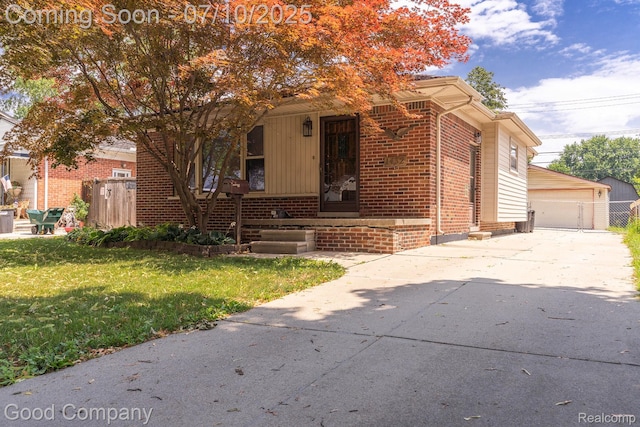 1432 N Custer Ave, Clawson, MI 48017 - view of front of house with brick siding, a front lawn, an outdoor structure, and covered porch