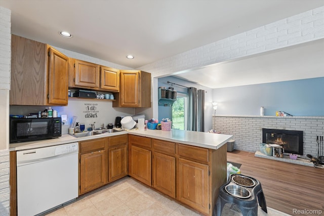 15447 Taft St, Westland, MI 48174 - kitchen with dishwasher, black microwave, a peninsula, light countertops, and a fireplace