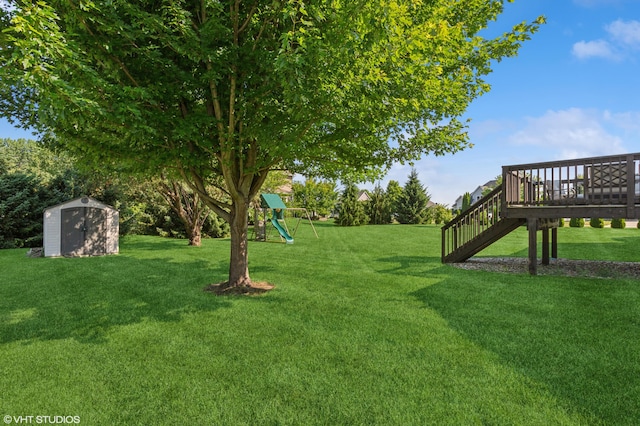 6044 Wabash Ln, Stevensville, MI 49127 - view of grassy yard with a storage shed, a playground, and a wooden deck