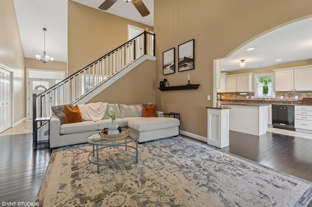 6044 Wabash Ln, Stevensville, MI 49127 - living area with a high ceiling, wood-type flooring, a ceiling fan, arched walkways, and a chandelier