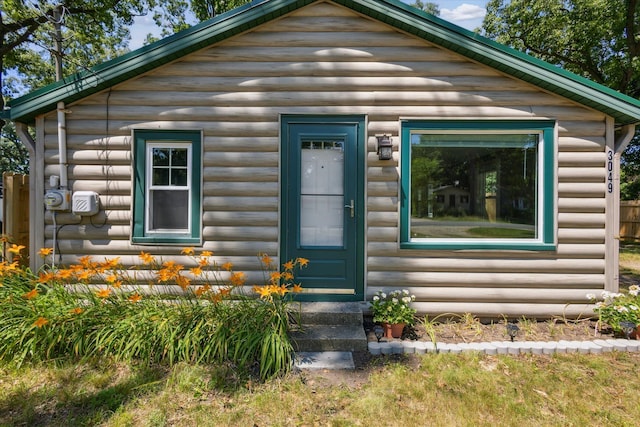 3049 Kooi St, Muskegon, MI 49444 - log home featuring faux log siding and entry steps