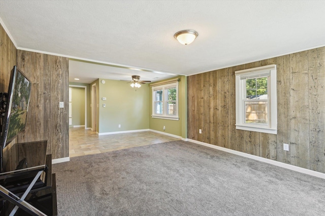 3049 Kooi St, Muskegon, MI 49444 - carpeted spare room featuring healthy amount of natural light, wooden walls, ceiling fan, and a textured ceiling