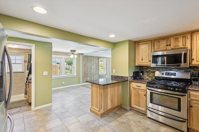 3049 Kooi St, Muskegon, MI 49444 - kitchen featuring stainless steel appliances, a peninsula, a ceiling fan, tasteful backsplash, and recessed lighting