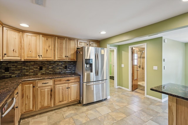 3049 Kooi St, Muskegon, MI 49444 - kitchen featuring appliances with stainless steel finishes, backsplash, recessed lighting, dark stone counters, and light brown cabinetry