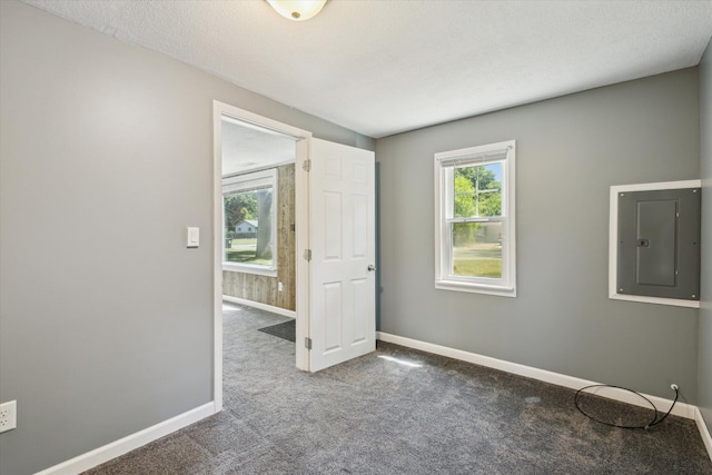 3049 Kooi St, Muskegon, MI 49444 - carpeted empty room featuring electric panel and baseboards