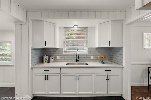 18714 Appoline St, Detroit, MI 48235 - kitchen with white cabinets, light countertops, backsplash, and dark wood finished floors