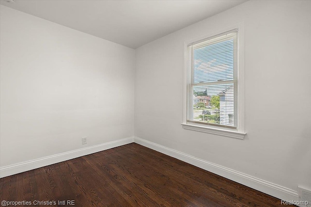 18714 Appoline St, Detroit, MI 48235 - empty room featuring baseboards and dark wood-type flooring