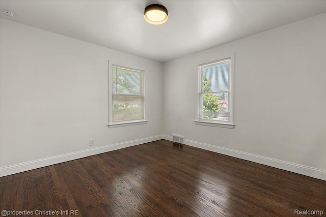18714 Appoline St, Detroit, MI 48235 - empty room featuring dark wood-style flooring and a smoke detector