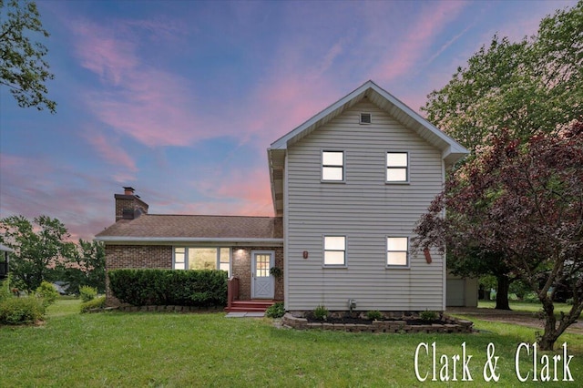 139 W Grand Ledge Hwy, Sunfield, MI 48890 - traditional-style home with a front yard, a chimney, and brick siding