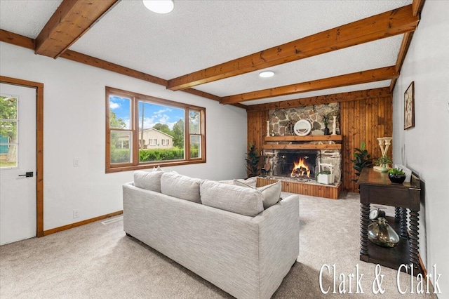 139 W Grand Ledge Hwy, Sunfield, MI 48890 - carpeted living area featuring beamed ceiling, plenty of natural light, and a stone fireplace