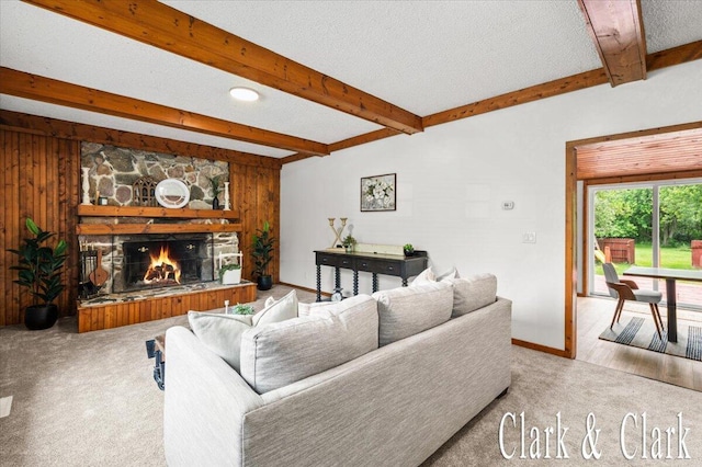 139 W Grand Ledge Hwy, Sunfield, MI 48890 - carpeted living area with beam ceiling and a stone fireplace