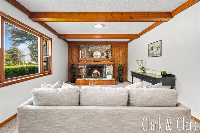 139 W Grand Ledge Hwy, Sunfield, MI 48890 - living room featuring beamed ceiling, carpet floors, and a stone fireplace