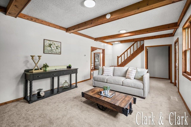 139 W Grand Ledge Hwy, Sunfield, MI 48890 - living area with carpet floors, beamed ceiling, stairs, and a textured ceiling