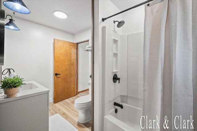 139 W Grand Ledge Hwy, Sunfield, MI 48890 - bathroom featuring wood finished floors, shower / bath combination with curtain, and vanity