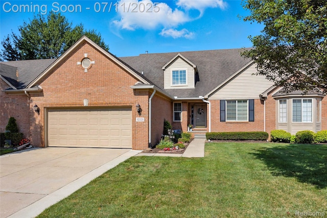 52221 Giuliano Ln, Macomb, MI 48042 - view of front facade featuring brick siding, a garage, driveway, a front yard, and roof with shingles