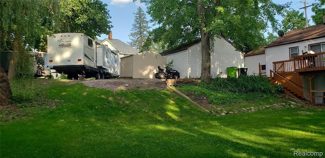 507 Main St, Fenton, MI 48430 - view of grassy yard featuring a wooden deck and stairs