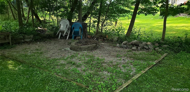 507 Main St, Fenton, MI 48430 - view of green lawn with a fire pit