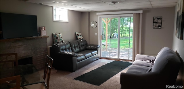 507 Main St, Fenton, MI 48430 - living room with a paneled ceiling, carpet, and a brick fireplace