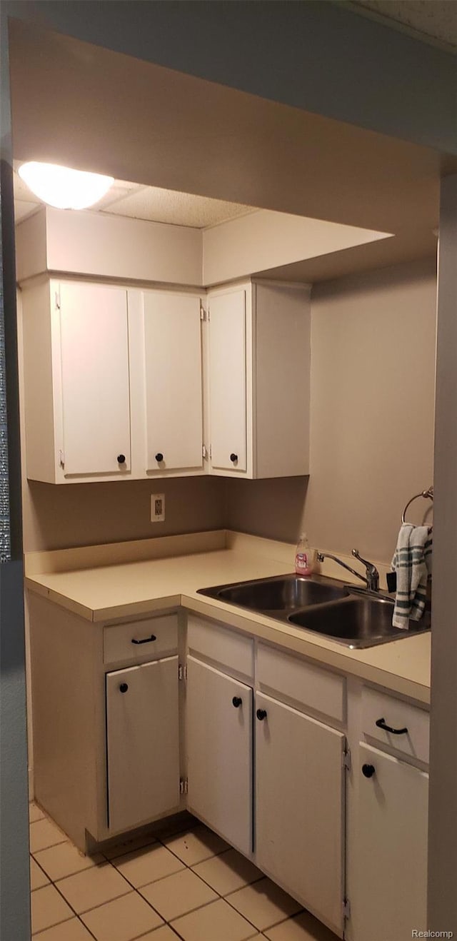 507 Main St, Fenton, MI 48430 - kitchen featuring white cabinets, light countertops, and light tile patterned floors