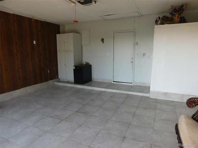 2238 Nadine Dr, Sterling Heights, MI 48310 - garage featuring wood walls and a garage door opener