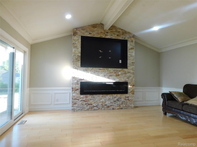 2238 Nadine Dr, Sterling Heights, MI 48310 - living area with a stone fireplace, wood finished floors, plenty of natural light, a wainscoted wall, and crown molding