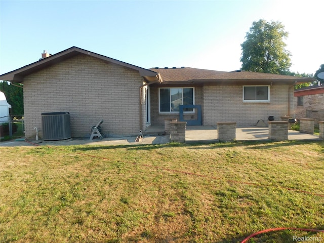 2238 Nadine Dr, Sterling Heights, MI 48310 - rear view of property featuring brick siding, a lawn, and a patio
