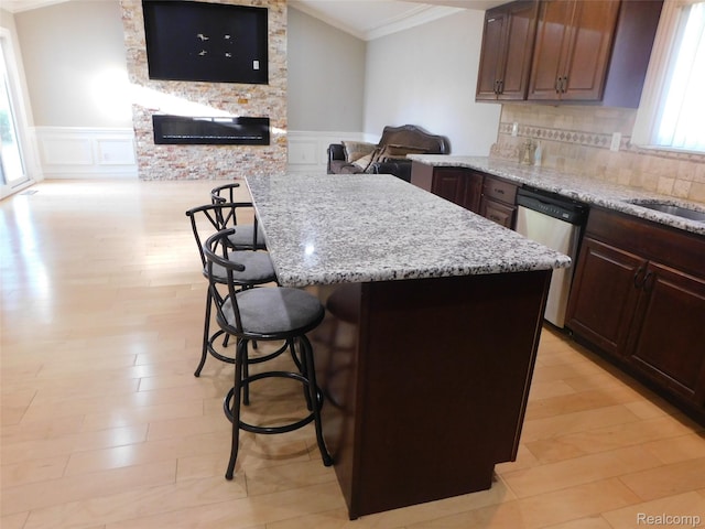 2238 Nadine Dr, Sterling Heights, MI 48310 - kitchen featuring ornamental molding, stainless steel dishwasher, a breakfast bar area, a wainscoted wall, and a decorative wall
