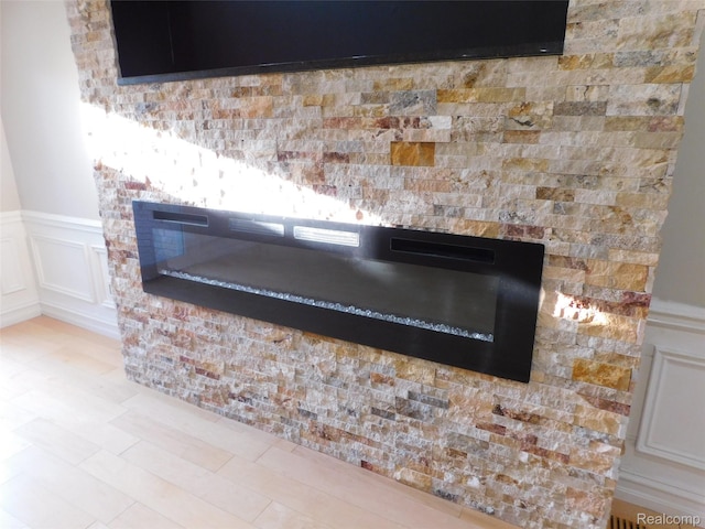 2238 Nadine Dr, Sterling Heights, MI 48310 - detailed view of a glass covered fireplace, a decorative wall, and wainscoting