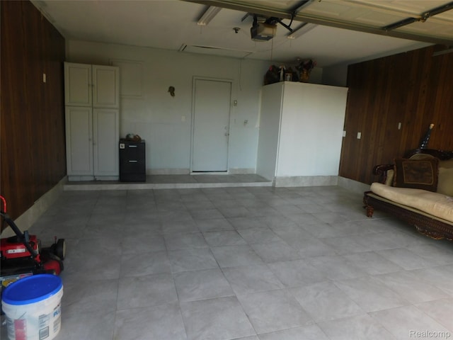 2238 Nadine Dr, Sterling Heights, MI 48310 - garage featuring wood walls and a garage door opener