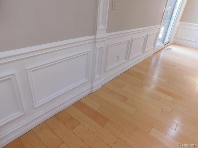 2238 Nadine Dr, Sterling Heights, MI 48310 - detailed view of wainscoting, wood finished floors, and a decorative wall