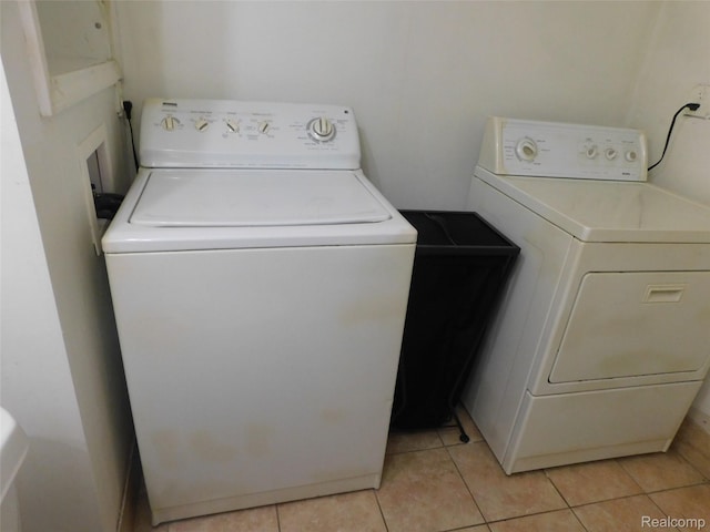 2238 Nadine Dr, Sterling Heights, MI 48310 - laundry area with washer and clothes dryer and light tile patterned floors