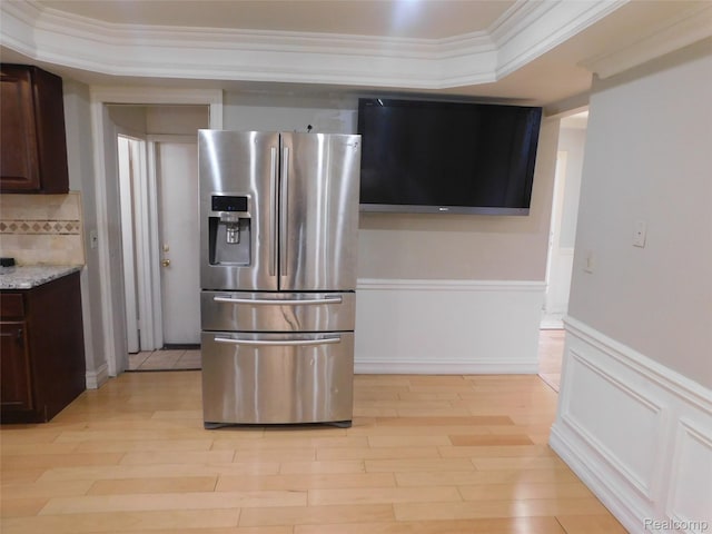 2238 Nadine Dr, Sterling Heights, MI 48310 - kitchen with stainless steel fridge, dark brown cabinetry, wainscoting, decorative backsplash, and light wood-type flooring