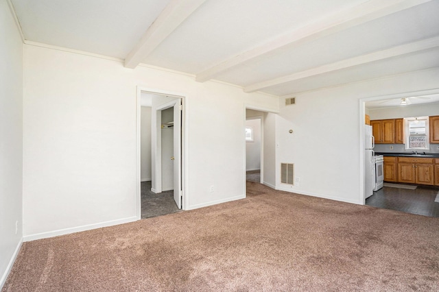 340 Nora St SE, Grand Rapids, MI 49548 - unfurnished living room with dark carpet and beamed ceiling