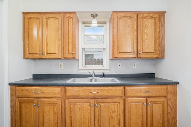 340 Nora St SE, Grand Rapids, MI 49548 - kitchen featuring dark countertops and brown cabinets