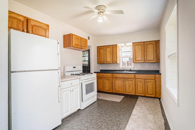 340 Nora St SE, Grand Rapids, MI 49548 - kitchen featuring white appliances, ceiling fan, brown cabinetry, and dark countertops