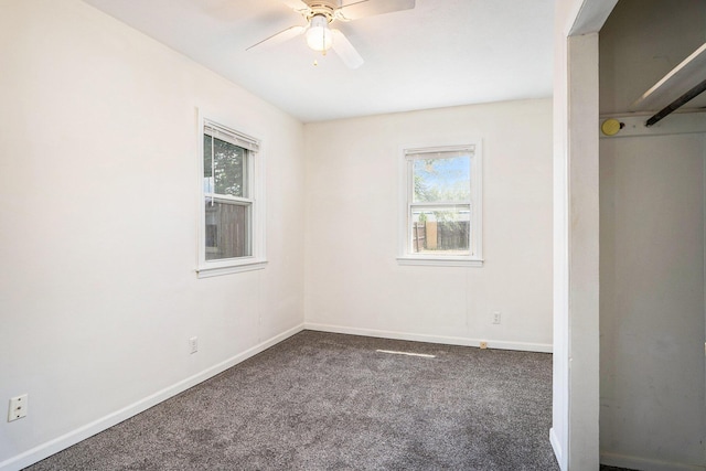 340 Nora St SE, Grand Rapids, MI 49548 - unfurnished bedroom with multiple windows, carpet flooring, and ceiling fan