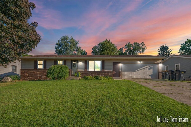 2958 Bluewater Ln SW, Grandville, MI 49418 - ranch-style house featuring driveway, a garage, brick siding, and a yard