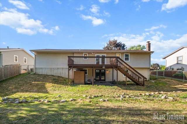 2958 Bluewater Ln SW, Grandville, MI 49418 - back of house with a wooden deck, stairway, a fenced backyard, and a chimney
