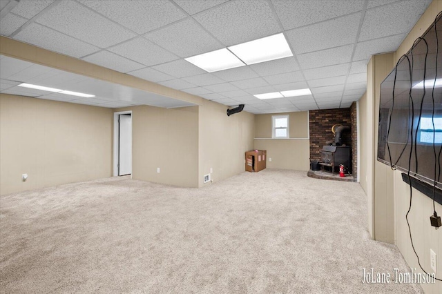 2958 Bluewater Ln SW, Grandville, MI 49418 - basement featuring a wood stove, a drop ceiling, and carpet floors