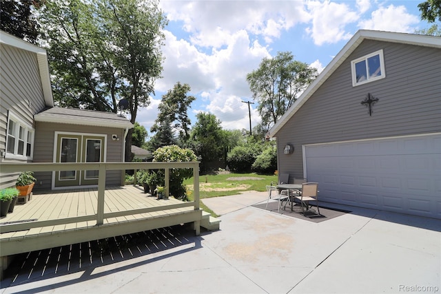 6500 Cooper St, Taylor, MI 48180 - view of patio featuring a wooden deck, a garage, french doors, and outdoor dining space