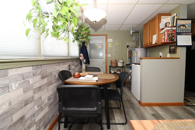 6500 Cooper St, Taylor, MI 48180 - dining room with a drop ceiling, light wood-style floors, and water heater