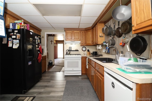6500 Cooper St, Taylor, MI 48180 - kitchen with white appliances, a paneled ceiling, light countertops, under cabinet range hood, and brown cabinetry