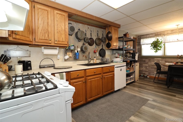 6500 Cooper St, Taylor, MI 48180 - kitchen with white appliances, light countertops, custom range hood, wood finished floors, and a paneled ceiling