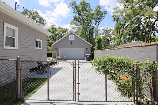 6500 Cooper St, Taylor, MI 48180 - view of side of property featuring a gate, a garage, and an outdoor structure