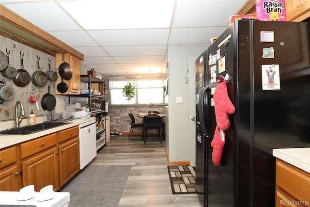 6500 Cooper St, Taylor, MI 48180 - kitchen with freestanding refrigerator, white dishwasher, brown cabinets, light countertops, and a drop ceiling