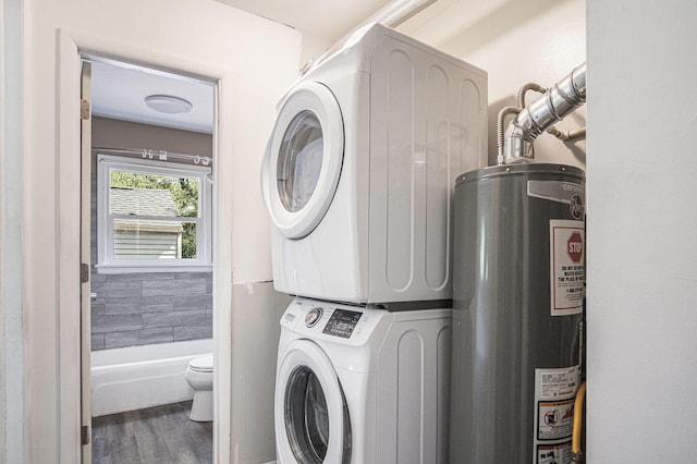 165 Kenton St SE, Grand Rapids, MI 49548 - laundry area with water heater, estacked washer and dryer, and wood finished floors