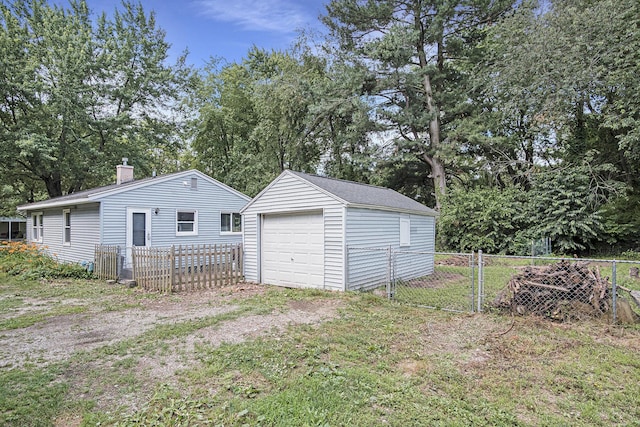 165 Kenton St SE, Grand Rapids, MI 49548 - detached garage featuring view of scattered trees and driveway