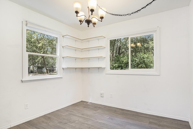 165 Kenton St SE, Grand Rapids, MI 49548 - spare room with a chandelier and wood finished floors