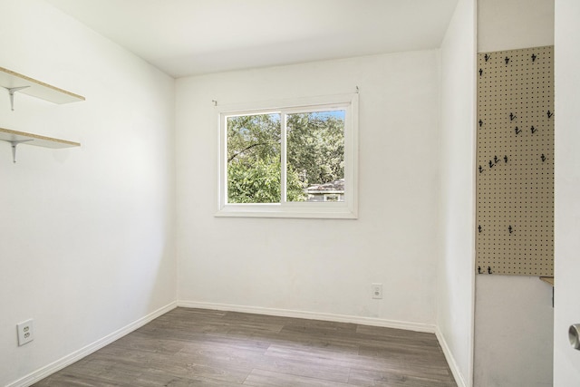 165 Kenton St SE, Grand Rapids, MI 49548 - unfurnished bedroom featuring wood finished floors and baseboards
